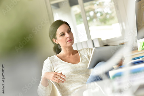 Businesswoman in office working on digital tablet