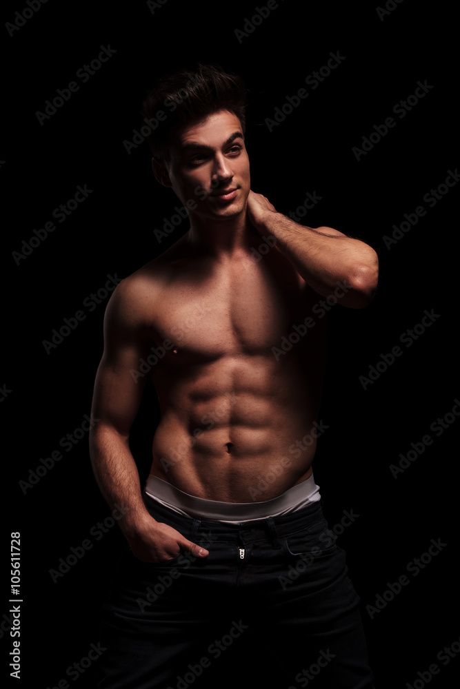 muscular man posing with hand in pocket