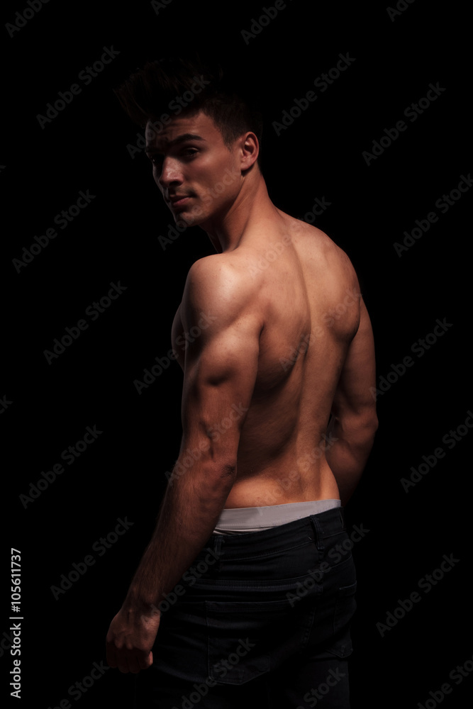 side portrait on standing muscular man