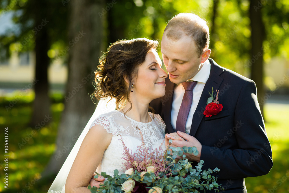 Beautiful bride and groom in the park on a sunny day Beautiful bride and groom in the park on a sunny day