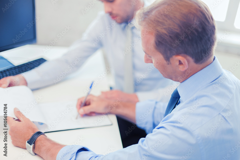 businessmen with notebook on meeting businessmen with notebook on meeting