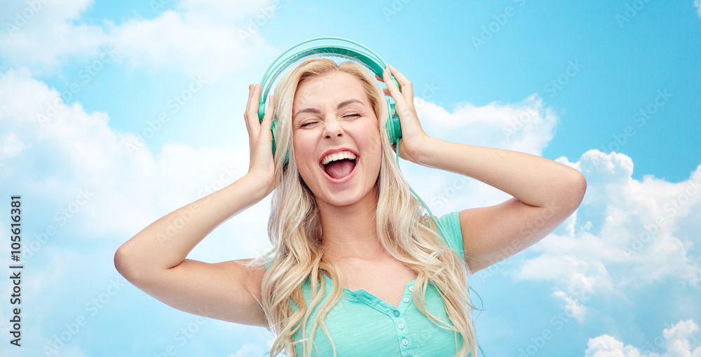 happy young woman or teenage girl with headphones