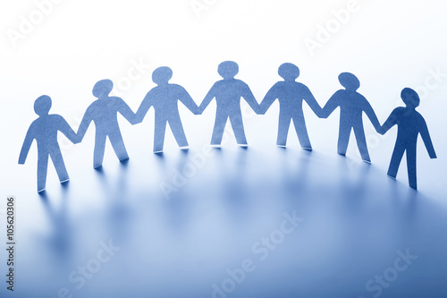 Paper people standing together hand in hand. Team, society, business concept photo