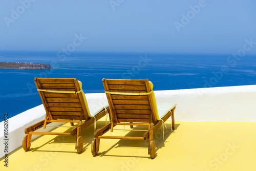 Big lounge chairs with sea view in Oia  Santorini  Greece