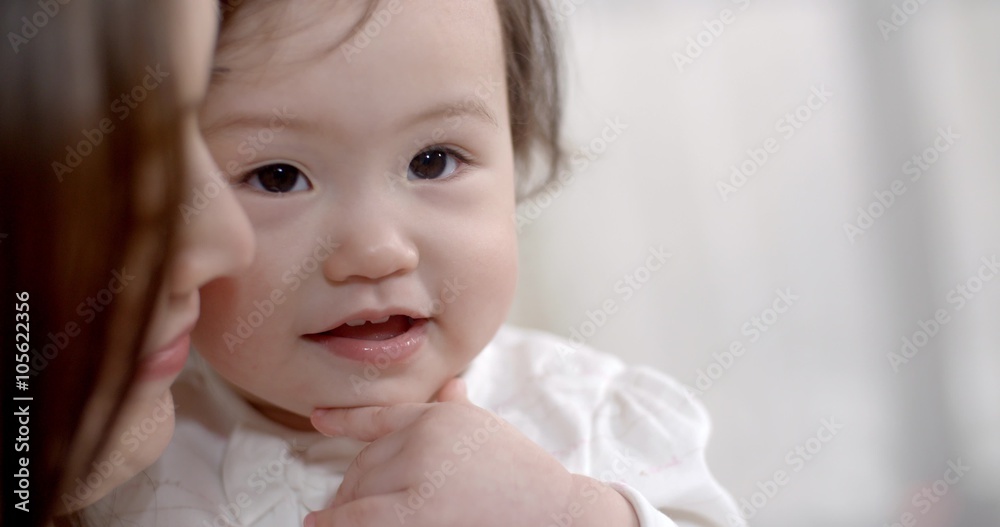 young Asian mother plays with her baby holding, happy emotions, baby laughing slow motion young Asian mother plays with her baby holding, happy emotions, baby laughing slow motion