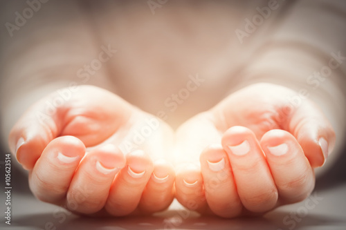 Canvastavla Light in woman's hands. Concepts of sharing, giving, new life