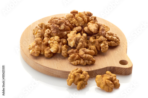 Walnuts on wooden board. Isolated on white background.