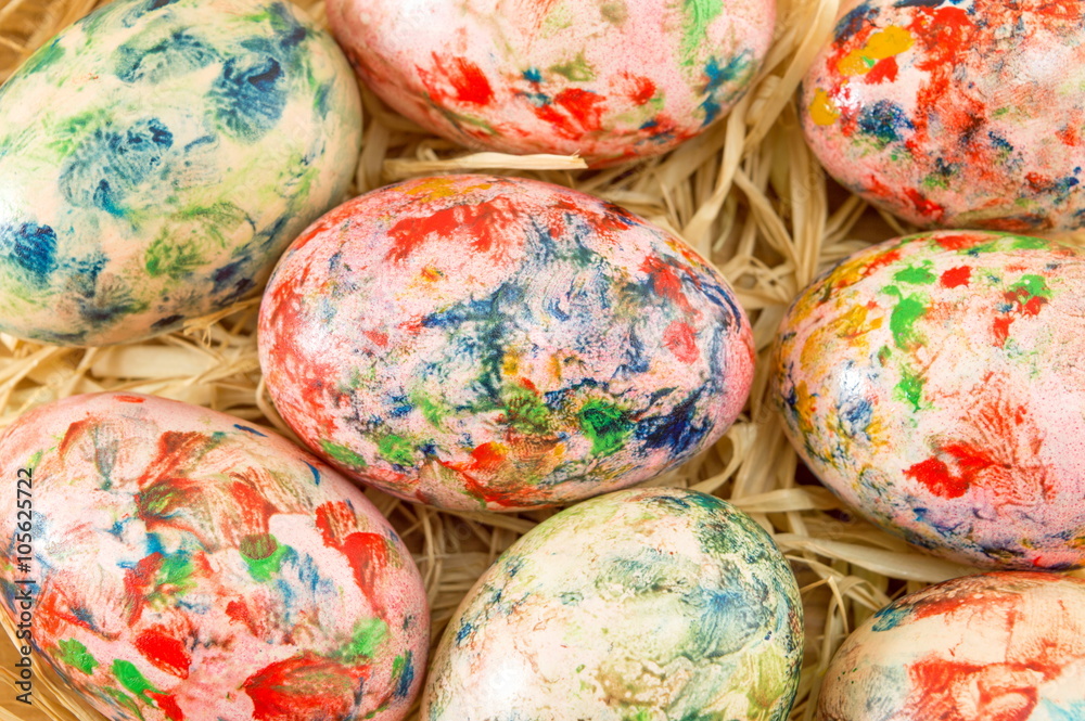 Painted Easter eggs on a straw nest Painted Easter eggs on a straw nest