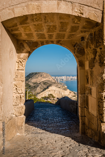 Alicante coastline, view through the arch of Santa Barbara castle