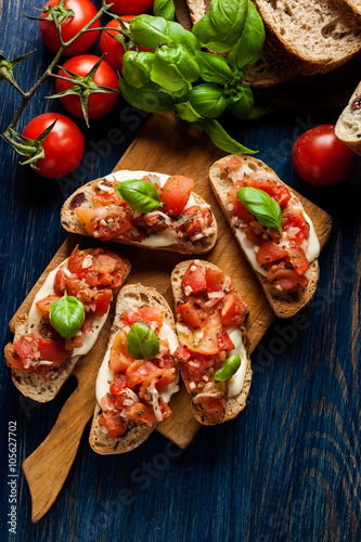 Italian bruschetta with roasted tomatoes, mozzarella cheese and