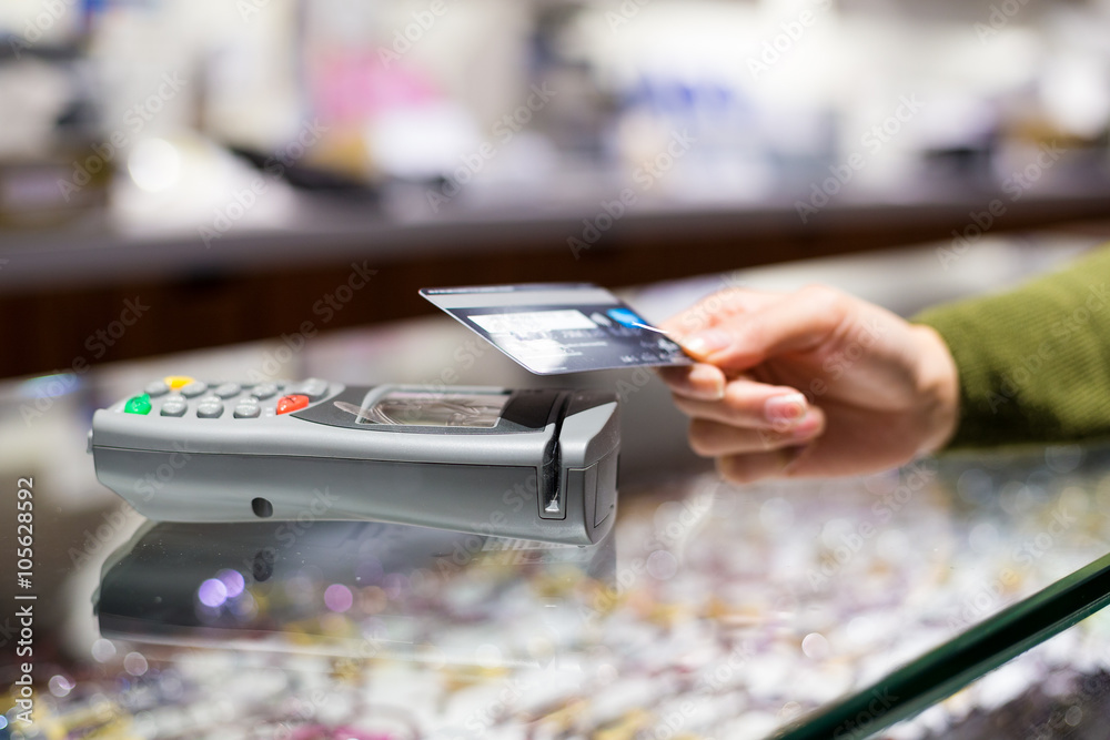 Fototapeta premium Woman paying with NFC technology on credit card