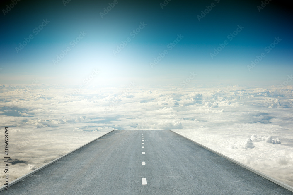 Road over clouds in sky