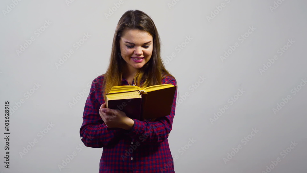 happy student girl reading books in front of white wall happy student girl reading books in front of white wall