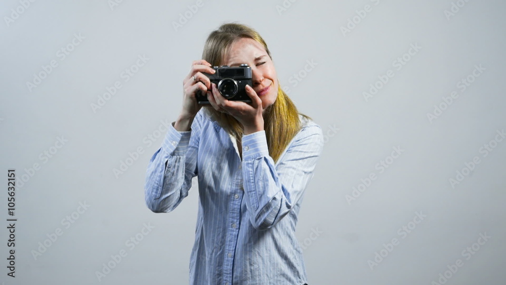 smiling young girl taking pictures with an old vintage camera smiling young girl taking pictures with an old vintage camera