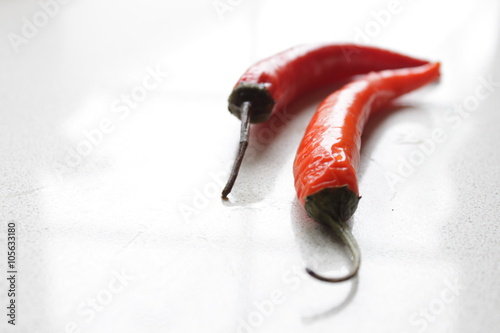 Red Chillies on a white surface, close-up  photo