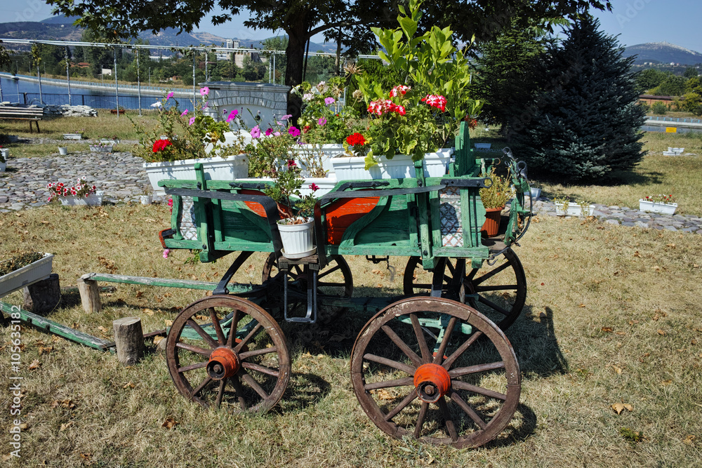 Wagon covered with flowers in the yard in Monastery St. John the Baptist, Kardzhali,  Bulgaria
