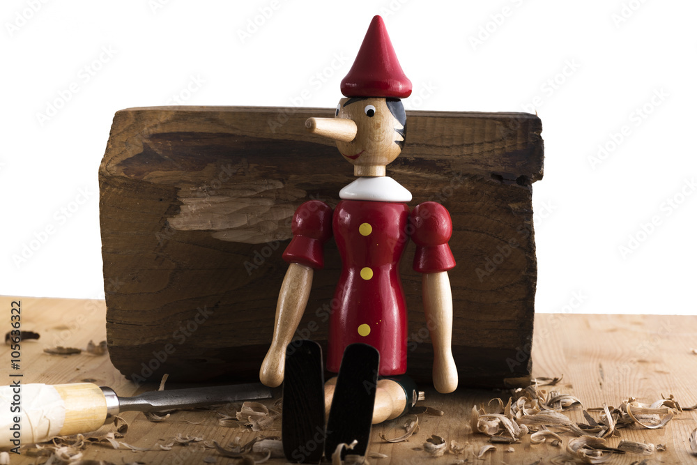 Photo & Art Print Puppet Pinocchio made of wood and then painted on a white  background