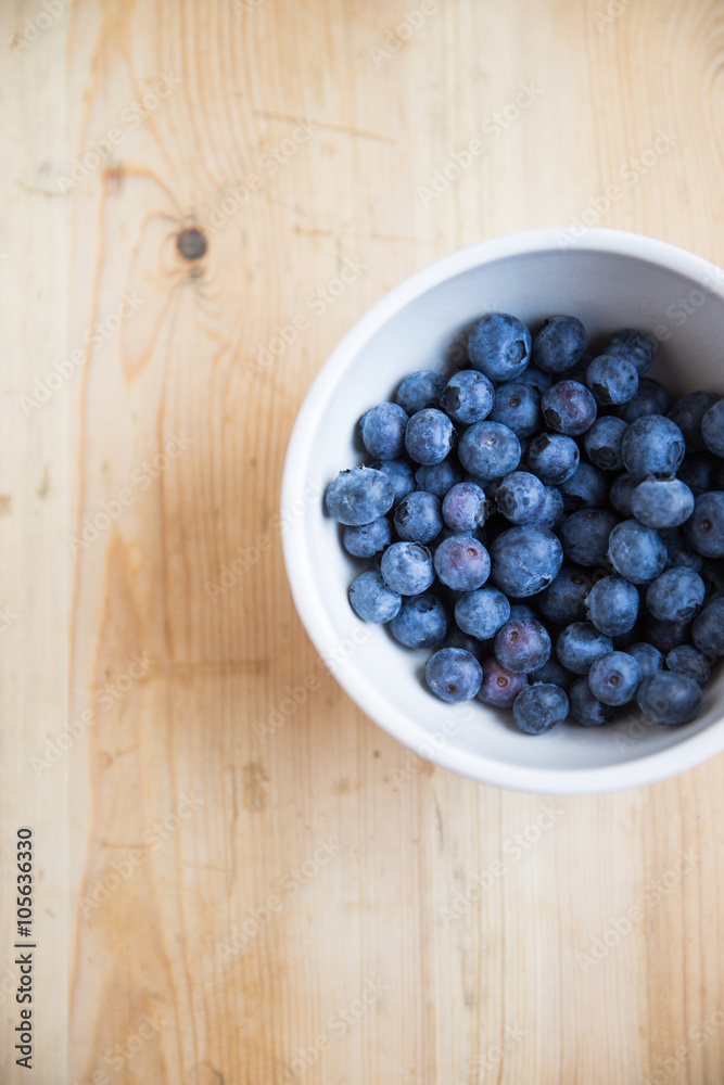 bowl of blueberries on wood table bowl of blueberries on wood table