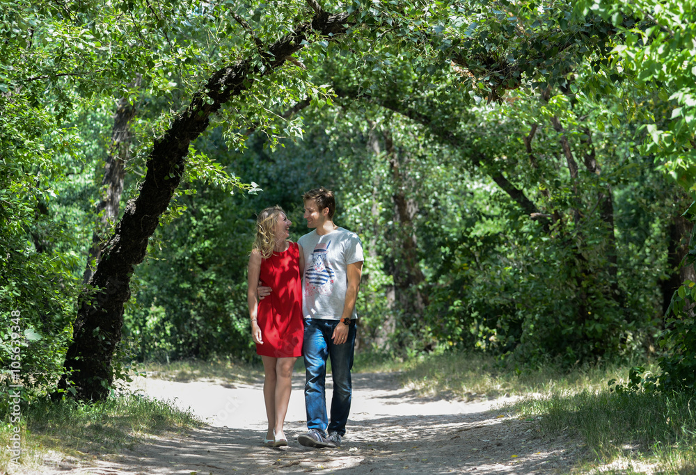 young pretty couple in the green summer park young pretty couple in the green summer park