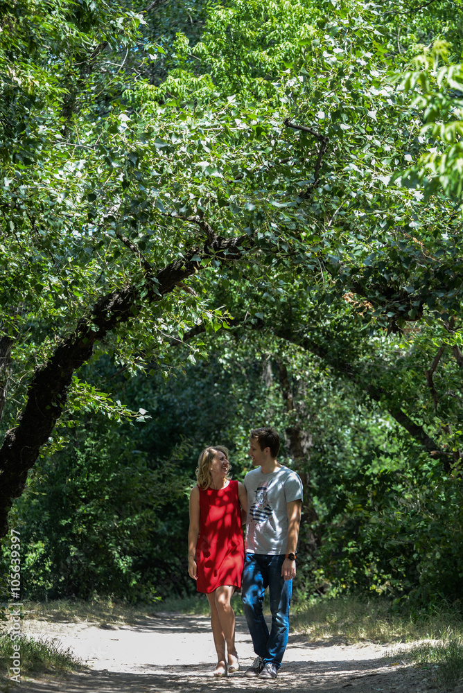 young pretty couple in the green summer park young pretty couple in the green summer park