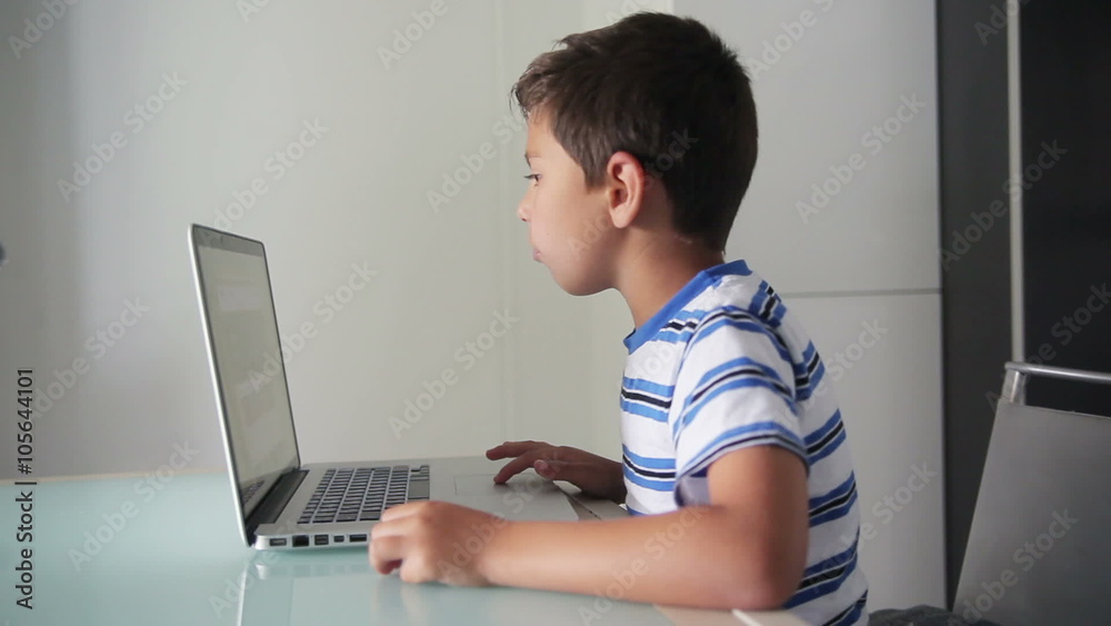 boy looks at a laptop boy looks at a laptop