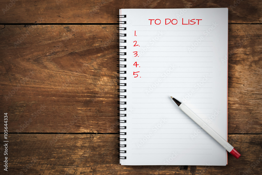 writing to do list on notepad with pen writing to do list on notepad with pen