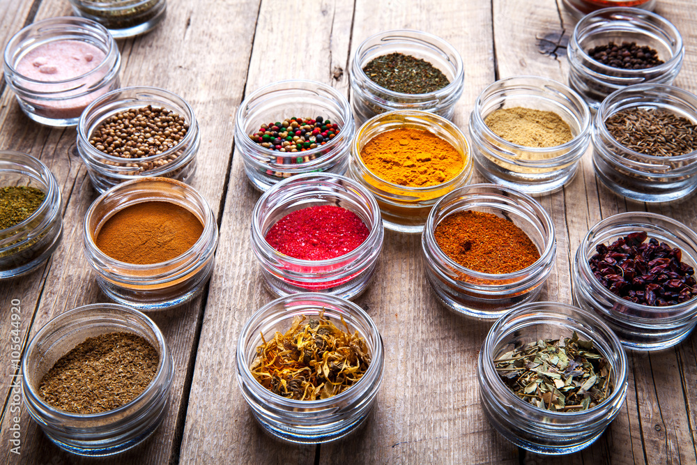Spices in jars on wooden background. Food Spices in jars on wooden background. Food