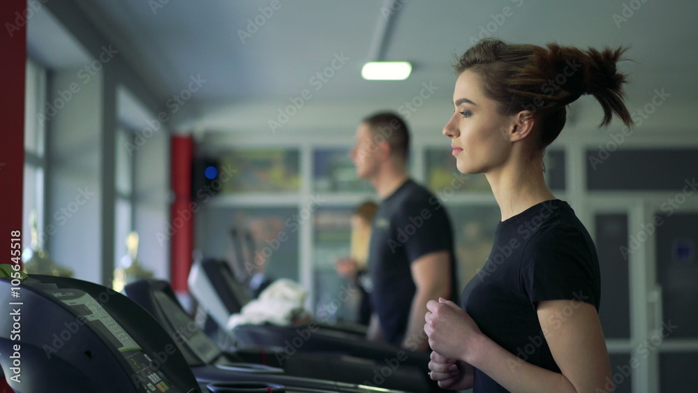 Young healthy woman running on treadmill. 4k Young healthy woman running on treadmill. 4k