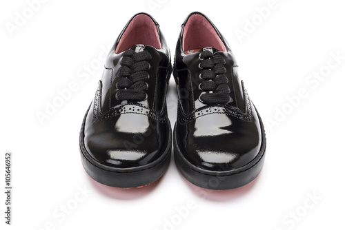 girls black school shoes on a white background