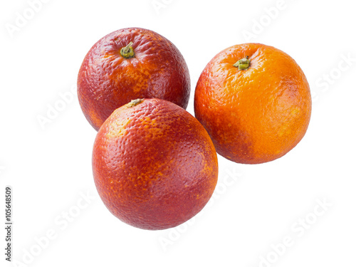 Three colorful red sicilian oranges isolated on white
