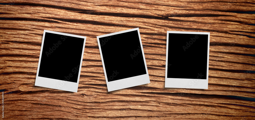 Fototapeta premium White paper picture frame on wood