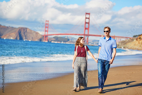 Romantic loving couple having a date on Baker beach in San Francisco photo
