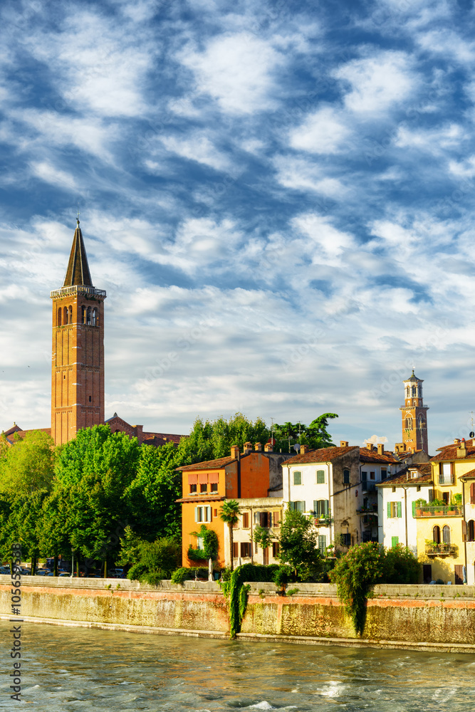 Houses on Adige waterfront and bell tower of church, Verona