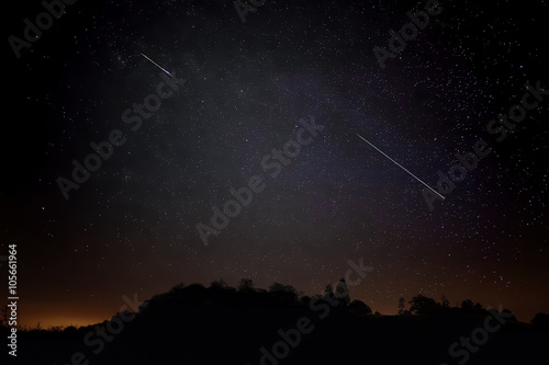 Two Meteros In Night Sky Of Stars, Sillouete Of Landscape photo