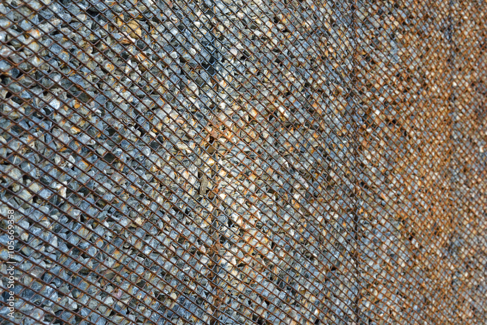 Fototapeta premium Background made from rusty metal mesh cage and stone