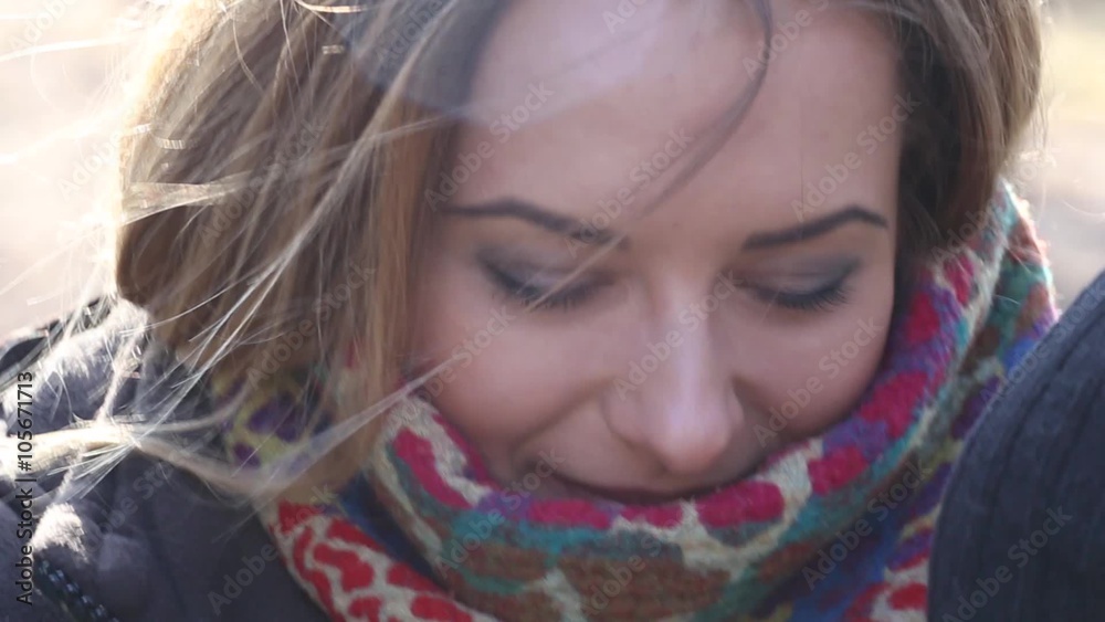 Close Up Of Young Woman's Eyes As She Smiles, Her Hair Blows In The Wind Close Up Of Young Woman's Eyes As She Smiles, Her Hair Blows In The Wind