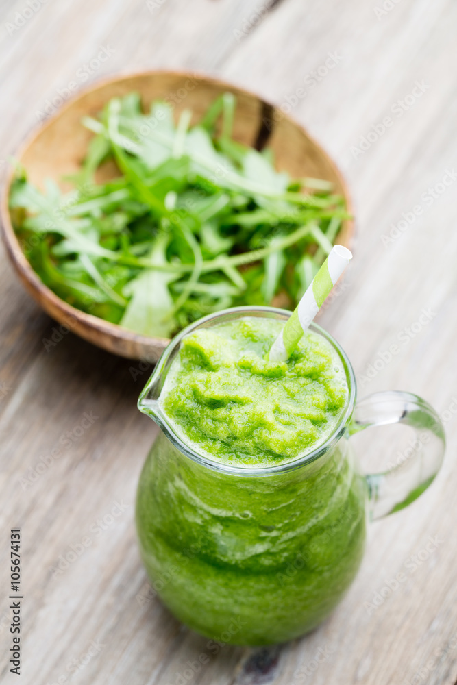 Rucola smoothie, on the grey background. Rucola smoothie, on the grey background.