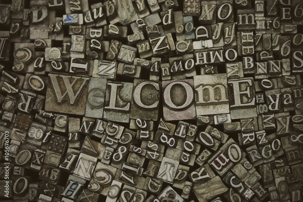 Close up of typeset letters with the word Welcome