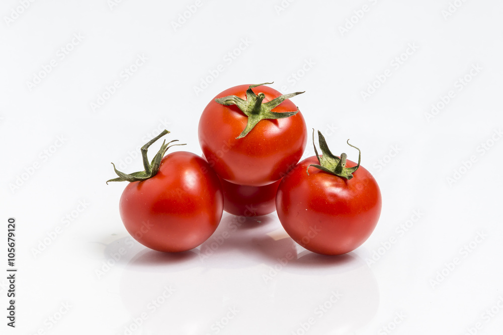 Bunch of the fresh tomatoes isolated on white Bunch of the fresh tomatoes isolated on white