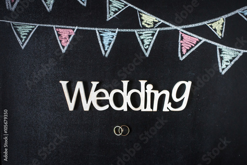 Chalkboard background with drawing bunting flags. Rings and wedd