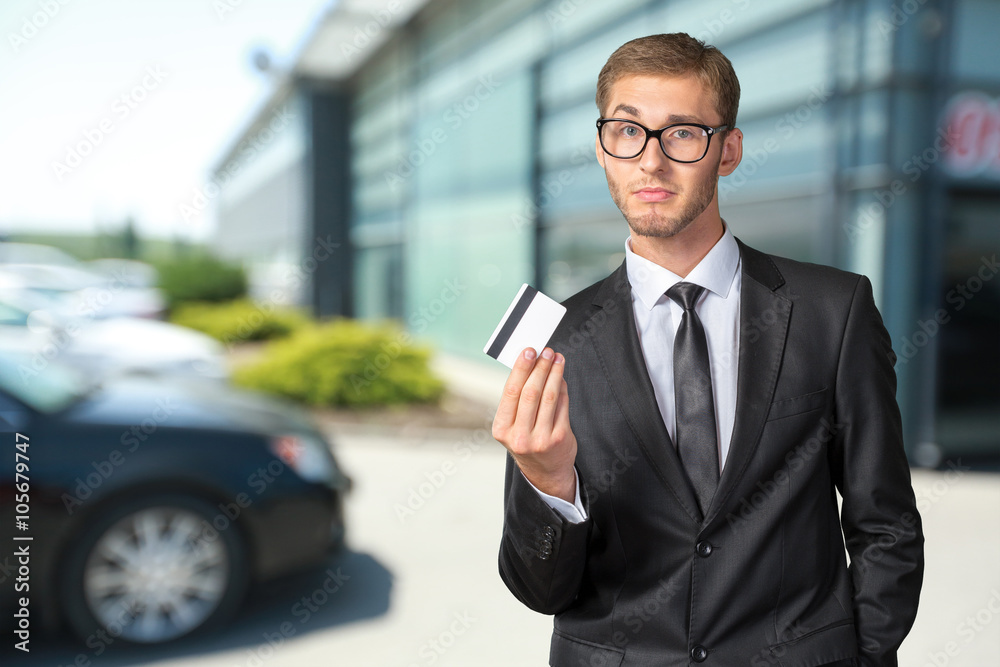 Young happy man holding credit card Young happy man holding credit card