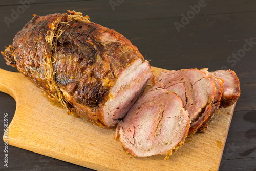 Roasted rolled pork meat on a cutting board
