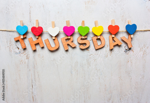 word Thursday from wooden letters on a white wooden background