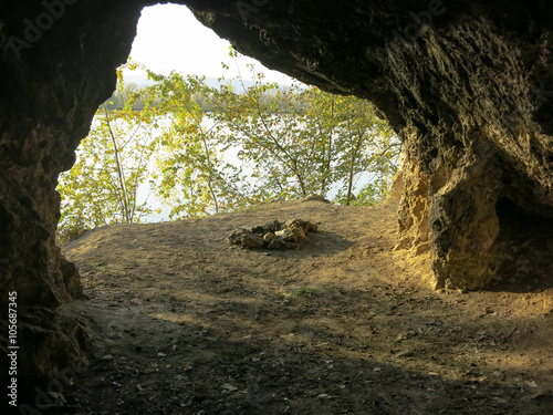 Cave inside with bonfire site. View near the entrance.