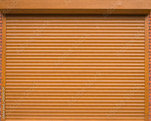 Orange roll gates with bricks on the sides