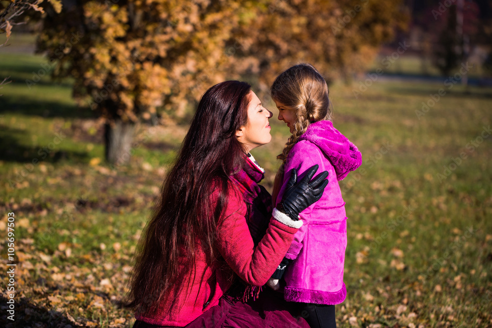 Mother and daughter in the park.happy mother and daughter in the autumn park Mother and daughter in the park.happy mother and daughter in the autumn park