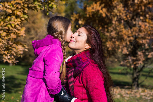 Mother and daughter in the park.happy mother and daughter in the autumn park