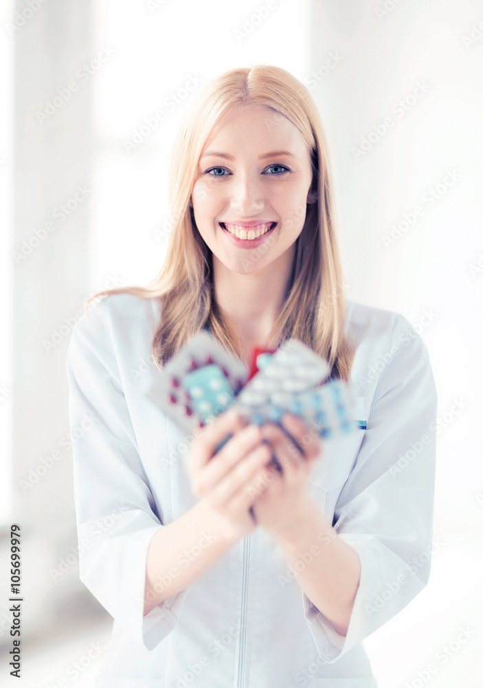 young female doctor with pack of pills