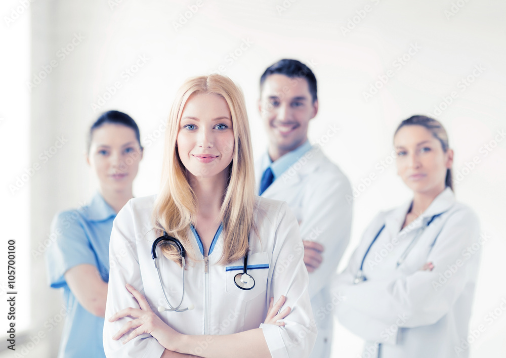 female doctor in front of medical group female doctor in front of medical group
