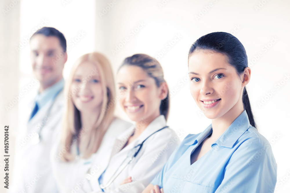 female doctor in front of medical group female doctor in front of medical group